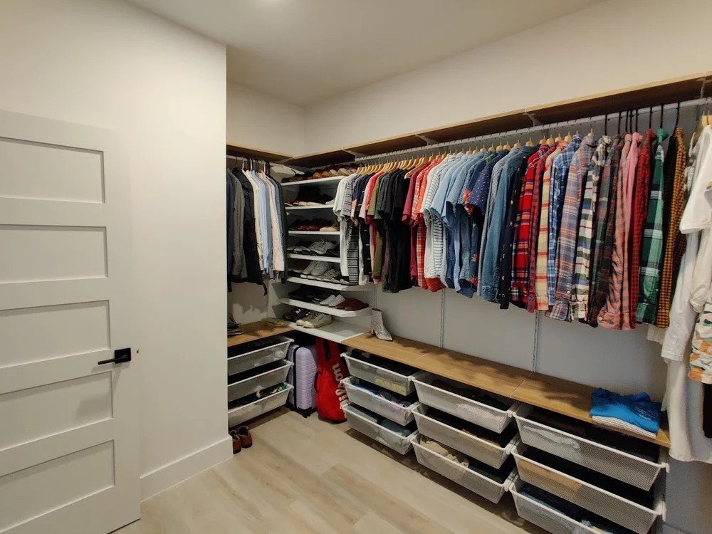Organized walk-in closet with custom shelving and pull-out bins